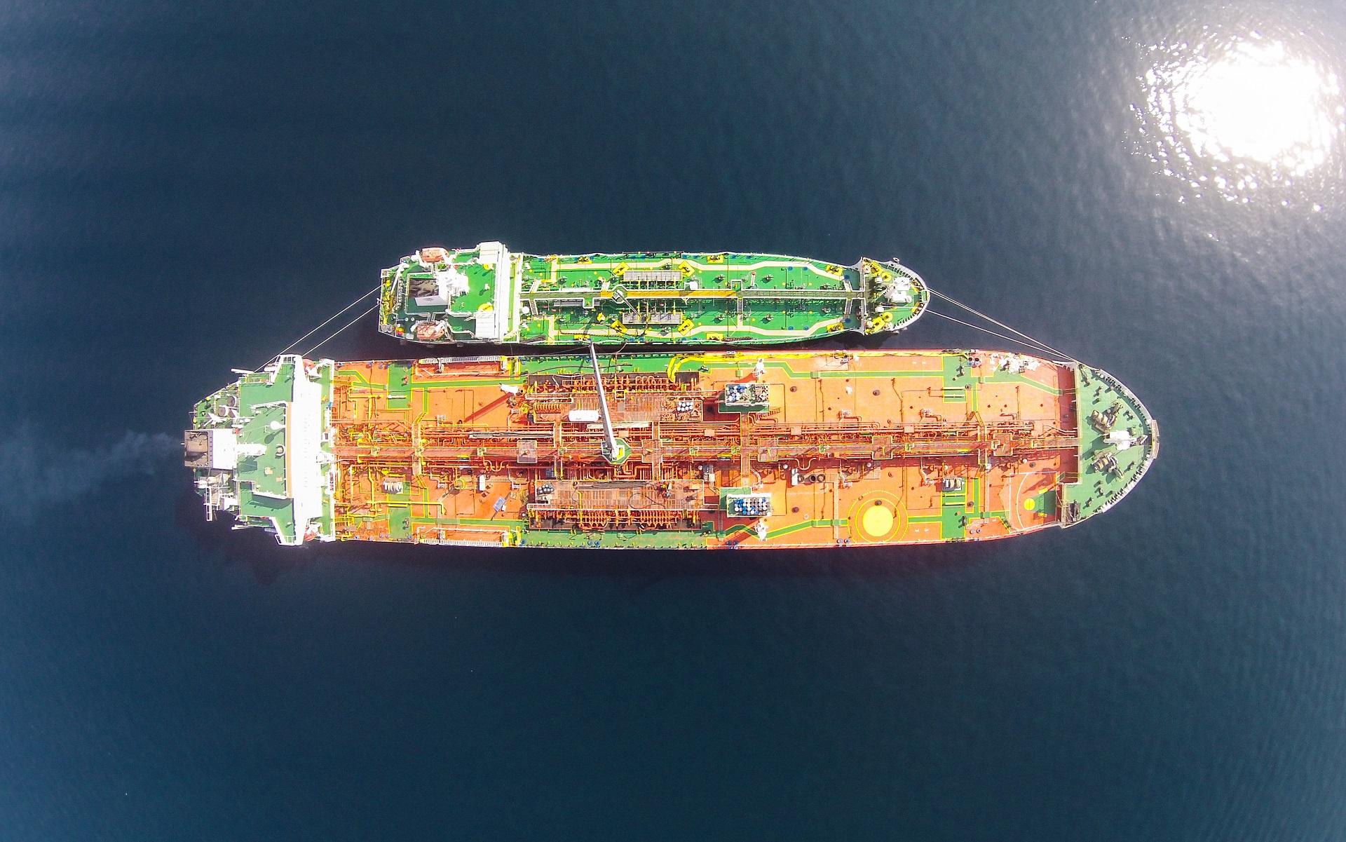 Two tankers moored side by side at sea, viewed from above